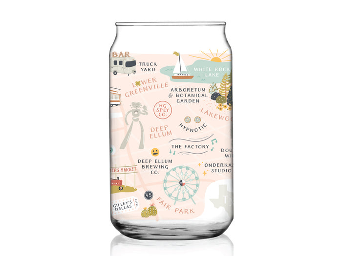 The Dallas Map Can Glass by Onderkast Studio is a clear glass cup featuring a vibrant city map illustration of Dallas, Texas with landmarks like White Rock Lake, Deep Ellum, Lower Greenville, Fair Park, local breweries, and parks.