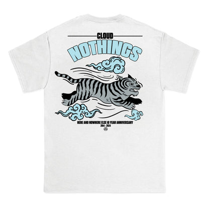 White Gildan Heavy t-shirt by Cloud Nothings, with a leaping black-striped tiger, blue clouds, and text: “CLOUD NOTHINGS” and “HERE AND NOWHERE ELSE 10 YEAR ANNIVERSARY 2014–2024.”.