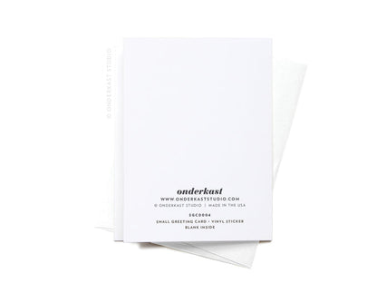 The Pour Yourself a Drink Darlin Cocktail Sticker Greeting Card by Onderkast Studio is printed on premium white card stock, with the brands logo and details in black on the back. It comes with a white envelope on a crisp white background.