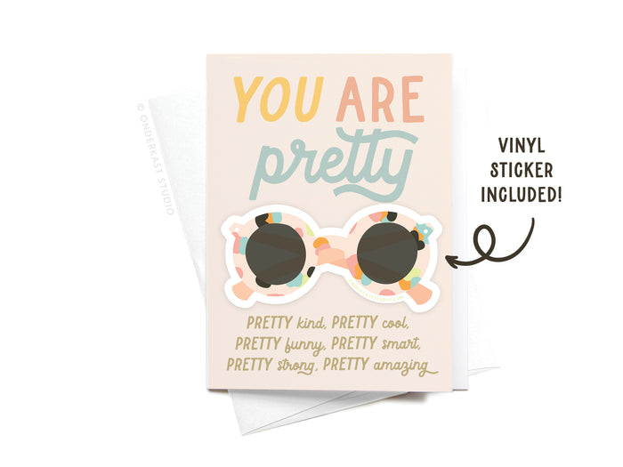The You Are Pretty Sunglasses Sticker Greeting Card by Onderkast Studio features YOU ARE pretty on thick white card stock, a colorful sunglasses vinyl sticker, uplifting words below, and comes with an envelope.